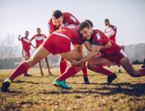 Rugby players tackling each other